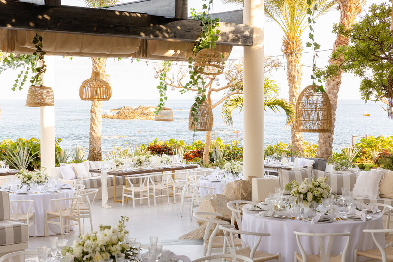 a dining set-up at a beachside wedding