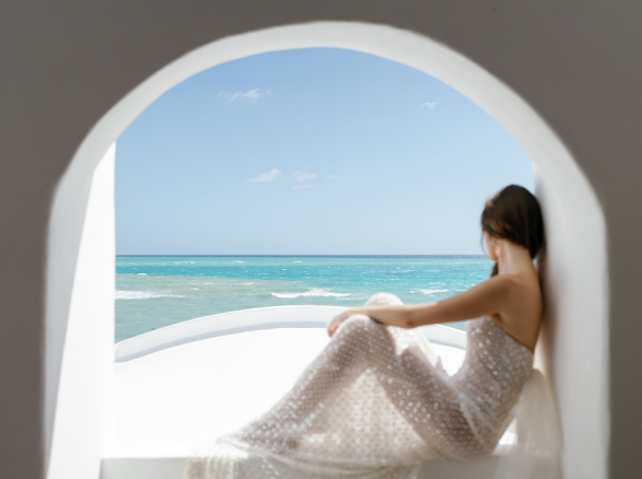 A bride sitting by the sea