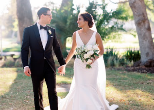 The bride and groom holding hands