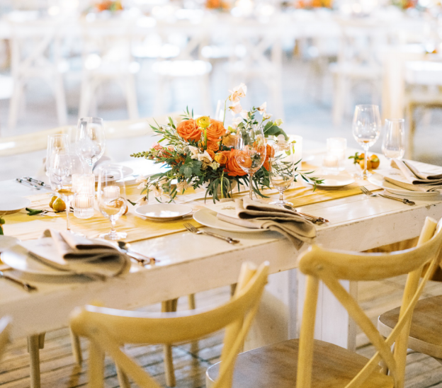 A plate on a table next to the center piece