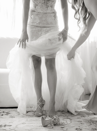 A bride having her dress adjusted before the ceremony