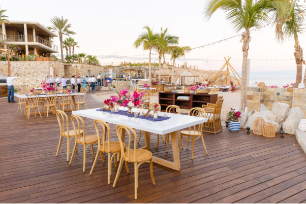 A beautifully arranged luxury wedding space with chic tables and exotic floral centerpieces