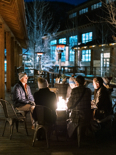 Wedding guests sitting around a fireplace.