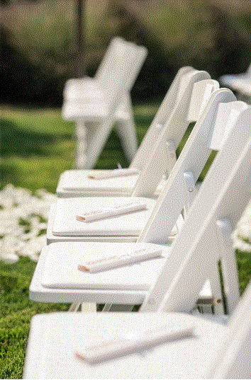 White chairs near a wedding altar.