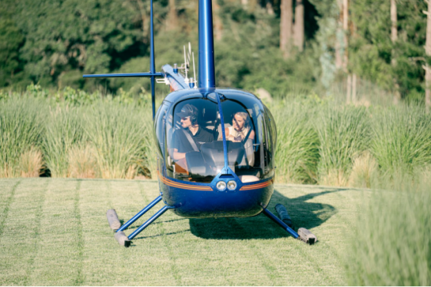 A couple is starting their honeymoon with a helicopter ride