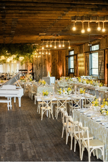 A luxury wedding reception with white chairs and a grand piano