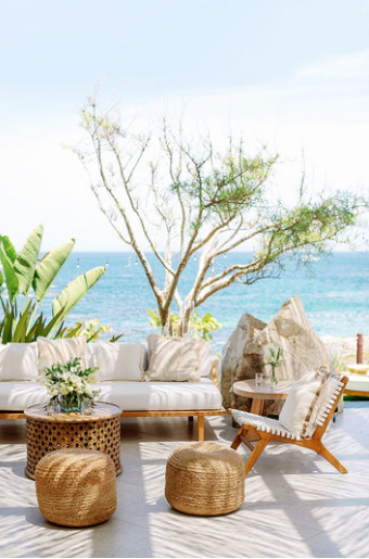 An oceanfront lounge setup with natural elements and serene coastal aesthetics.