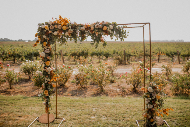 A metal frame adorned with flowers for a luxury wedding.