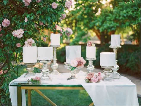 This cake table features sleek, contemporary cakes adorned with soft florals.
