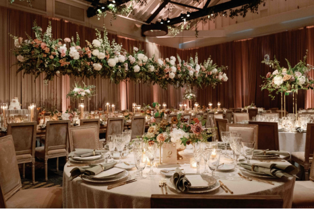 A reception setup with floating floral installations and candlelit tables for a luxury wedding.