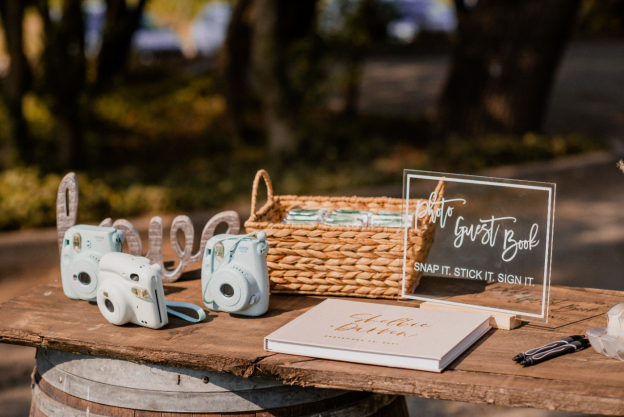 A table with an album and Polaroid cameras to make a luxury wedding album
