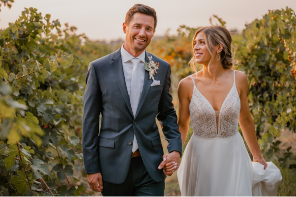 A couple holding hands at their wedding