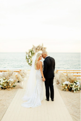 Bride and groom at a breathtaking coastal destination wedding ceremony.