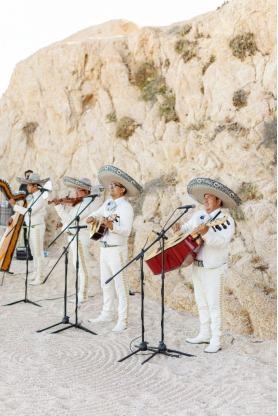 A mariachi band performing against a rocky backdrop during a vibrant wedding ceremony