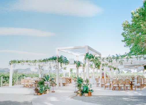 A beautifully arranged wedding seating area with fine linens, elegant floral accents, and soft ambient lighting, designed for a relaxed yet luxurious celebration