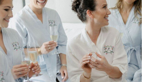 A bride smiling with her bridesmaids