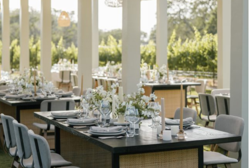 A brunch table set with place cards, pastries, and fresh florals