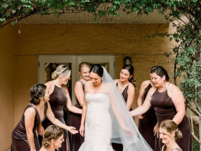 A bride in a sleek, contemporary wedding dress with minimalist detailing.