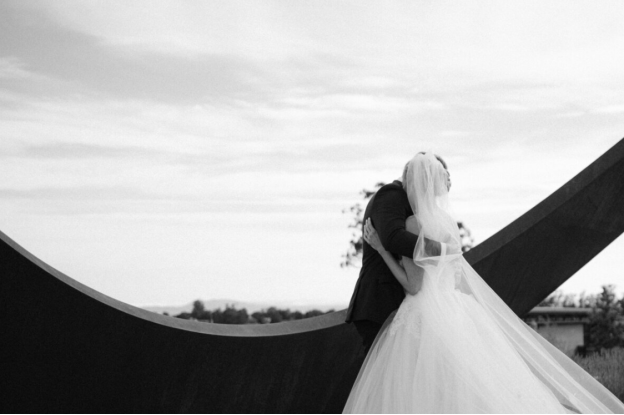 Married couple hugging after wedding reception  