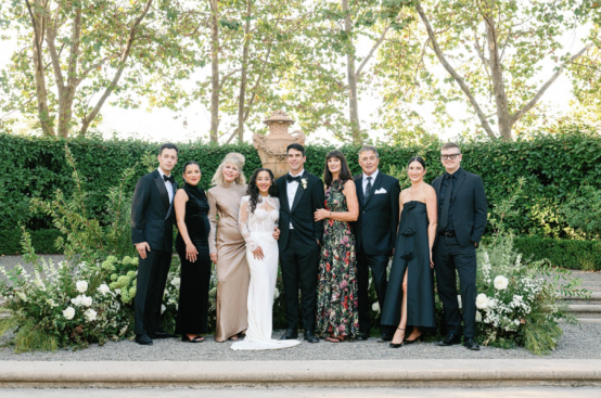 A bride and groom with their families