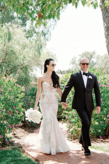 A couple entering their wedding reception