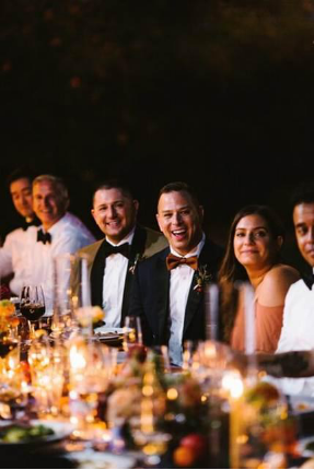 Wedding guests having dinner with a newly wedded couple
