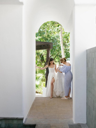 a bride being led inside a room.