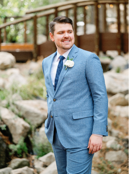 An image of a groom posing for a portrait