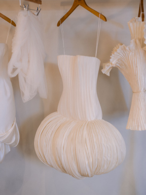 Couture bridal gown hanging in a styling room.
