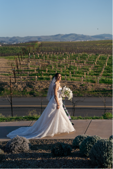 a bride walking holding a bouquet.