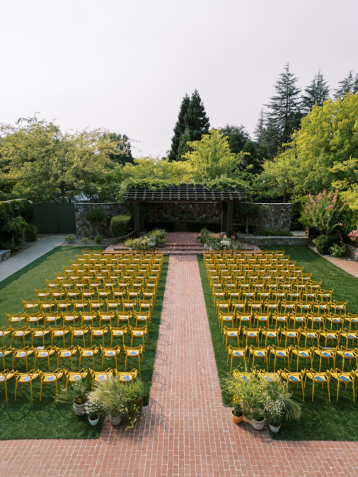 a wedding reception with yellow chairs.