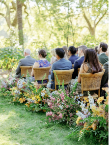 An image of wedding guests sitting outdoors   