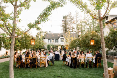 An image of guests talking while sitting at an outdoor party 