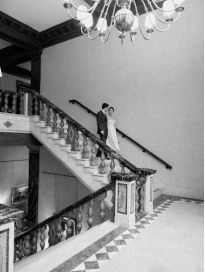 An image of a bride and groom going down the stairs