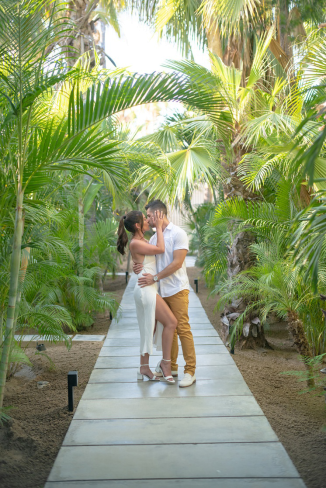 A couple kissing at their wedding reception in the Caribbean.