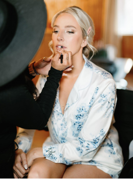 a makeup expert at work with a bride
