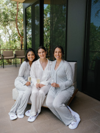An image of a bride in a night suit with her bridesmaids 