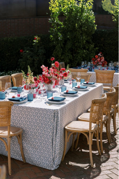 wicker chairs around a table at a wedding reception