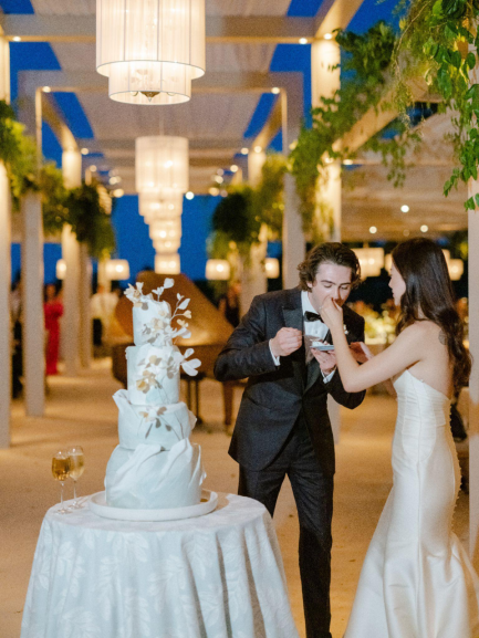 A couple enjoys their wedding cake.
